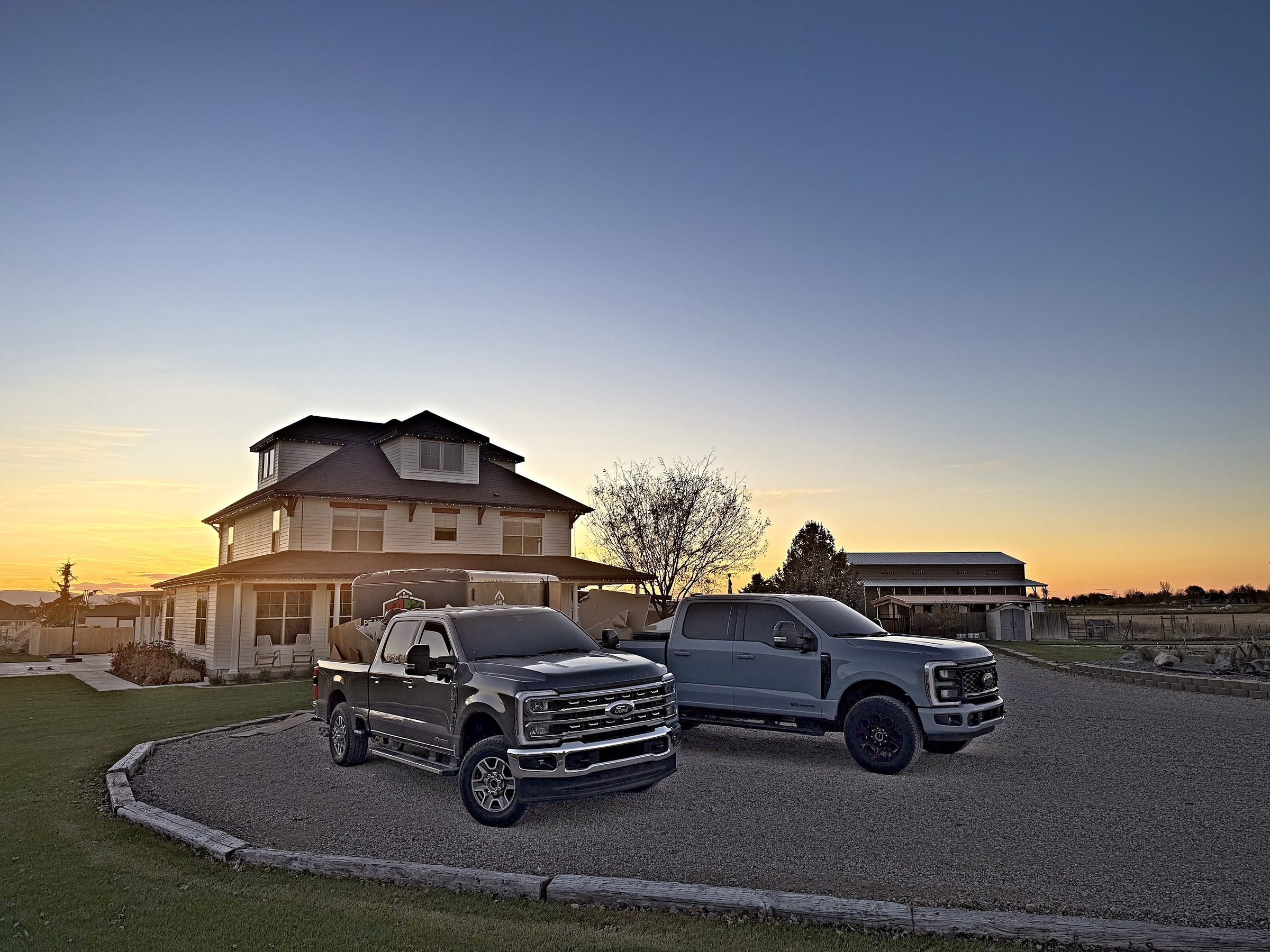 Peak Performance Restoration trucks at a Treasure Valley home at sunset